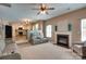Spacious living room with a fireplace, plush seating, open floor plan, and seamless transition to the kitchen at 136 Elba Dr, Mooresville, NC 28115
