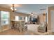 Open-concept living room with bar seating, ceiling fan, neutral tones, and comfortable seating area at 136 Elba Dr, Mooresville, NC 28115
