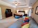 Spacious main bedroom boasts a tray ceiling, natural light and sitting area with comfortable sofa at 136 Elba Dr, Mooresville, NC 28115