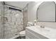 Elegant bathroom featuring marble tiling in the shower with a unique geometric tile floor at 137 S Penny St, Lancaster, SC 29720