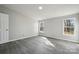 Bright bedroom featuring gray walls, wood-look flooring, natural light, and neutral finishes at 137 S Penny St, Lancaster, SC 29720