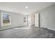 Bright bedroom with two windows, neutral walls, and gray wood-look floors at 137 S Penny St, Lancaster, SC 29720