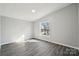 Bright bedroom with light-colored walls and a window overlooking the yard at 137 S Penny St, Lancaster, SC 29720