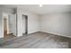 Neutral bedroom featuring gray walls, wood-look flooring, and a closet at 137 S Penny St, Lancaster, SC 29720