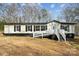 Charming home with white siding, black trim and a welcoming entrance staircase at 137 S Penny St, Lancaster, SC 29720