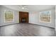Cozy living room showcasing a brick fireplace, wood-look flooring, and natural light from windows at 137 S Penny St, Lancaster, SC 29720