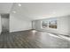 Bright living room with neutral walls, wood-look flooring, and natural light at 137 S Penny St, Lancaster, SC 29720