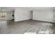 Expansive living room featuring continuous wood-look flooring and neutral walls at 137 S Penny St, Lancaster, SC 29720