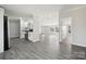 Open-concept layout showcasing the kitchen and living areas with wood-look flooring and neutral paint at 137 S Penny St, Lancaster, SC 29720