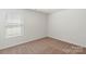 Bedroom featuring a large window with blinds and neutral carpet flooring at 1542 Doran Ter, Richburg, SC 29729