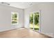 Bright, airy living room featuring a sliding glass door and large windows with backyard views at 1542 Doran Ter, Richburg, SC 29729