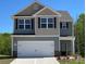 Charming two-story home features a two-car garage, a mix of stone and siding, and a well-manicured lawn at 1544 Doran Ter, Richburg, SC 29729