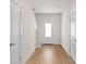 Bright hallway featuring wood-look floors and white doors, leading to various rooms within the home at 1546 Doran Ter, Richburg, SC 29729