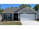 Charming single-story home with a two-car garage, gray siding, and a well-manicured lawn at 1550 Doran Ter, Richburg, SC 29729