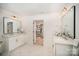 An updated bathroom features a double sink vanity, sleek faucets, and a walk-in closet at 16432 Here At Last Ln, Charlotte, NC 28278