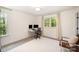 A bright bedroom features a desk with dual monitors, a chair, and a window offering natural light at 16432 Here At Last Ln, Charlotte, NC 28278