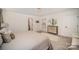 A light and bright bedroom boasts a decorative lighting fixture, ensuite bath, and walk-in closet at 16432 Here At Last Ln, Charlotte, NC 28278