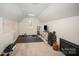 A carpeted bonus room features white walls and window with view of nature. A perfect flex space at 16432 Here At Last Ln, Charlotte, NC 28278