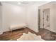 Bonus room with beautiful hardwood floors, plush rug and a doorway to another room at 16432 Here At Last Ln, Charlotte, NC 28278