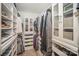 Custom walk-in closet offers ample storage with built-in shelving, drawers, and hanging space at 16432 Here At Last Ln, Charlotte, NC 28278