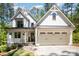 Beautiful two-story farmhouse with white siding, black trim, and a welcoming front porch and attached garage at 16432 Here At Last Ln, Charlotte, NC 28278