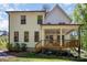 Rear exterior view featuring a two-story home with a covered porch and lush green lawn at 16432 Here At Last Ln, Charlotte, NC 28278