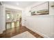 Elegant foyer with hardwood floors, wainscoting, a decorative painting, and an open view to living area at 16432 Here At Last Ln, Charlotte, NC 28278