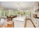 Open kitchen with island seating, stainless steel appliances, and hardwood floors that seamlessly transition to dining area at 16432 Here At Last Ln, Charlotte, NC 28278