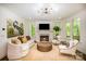 Bright living room featuring hardwood floors, fireplace, stylish furniture, and natural light at 16432 Here At Last Ln, Charlotte, NC 28278