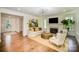 Bright living room featuring hardwood floors, fireplace, stylish furniture, and an artistic accent wall at 16432 Here At Last Ln, Charlotte, NC 28278
