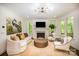 Bright living room featuring hardwood floors, fireplace, stylish furniture, and natural light at 16432 Here At Last Ln, Charlotte, NC 28278