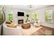 Bright living room featuring hardwood floors, fireplace, stylish furniture, and natural light at 16432 Here At Last Ln, Charlotte, NC 28278
