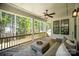 Inviting covered porch with comfortable seating, ceiling fan, and scenic outdoor views at 16432 Here At Last Ln, Charlotte, NC 28278