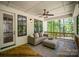 Relaxing covered porch features cozy seating and scenic views of the surrounding greenery at 16432 Here At Last Ln, Charlotte, NC 28278