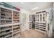 A well-organized walk-in closet features custom shelving for shoes, drawers, and hanging storage at 16432 Here At Last Ln, Charlotte, NC 28278