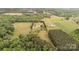 Expansive property with a long driveway, main house, outbuildings and bordered by lush trees at 1720 Lowe Dr, Catawba, NC 28609