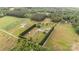 Aerial view of a large property featuring multiple structures and expansive green spaces with surrounding trees at 1720 Lowe Dr, Catawba, NC 28609