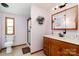 Neat bathroom features a framed mirror and single sink vanity with storage underneath at 1720 Lowe Dr, Catawba, NC 28609
