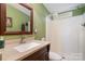 Bathroom with a single sink vanity, framed mirror, and a shower-tub combo at 1720 Lowe Dr, Catawba, NC 28609