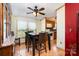 Cozy dining room with wood laminate flooring, a ceiling fan, and a view of the outside at 1720 Lowe Dr, Catawba, NC 28609
