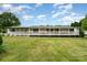 Charming home featuring a wide, inviting porch with white railings and green shutters, surrounded by a lush green lawn at 1720 Lowe Dr, Catawba, NC 28609