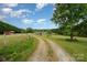 Charming home featuring a long driveway and beautiful green lawn, perfect for outdoor activities at 1720 Lowe Dr, Catawba, NC 28609