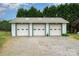 Detached three-car garage with white doors and a gravel driveway, providing ample parking and storage space at 1720 Lowe Dr, Catawba, NC 28609
