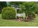 Charming garden featuring a decorative swing, surrounded by lush greenery and vibrant flowers at 1720 Lowe Dr, Catawba, NC 28609