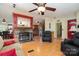 Inviting living room features a stone fireplace, ceiling fan, and wood laminate flooring at 1720 Lowe Dr, Catawba, NC 28609