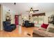 Inviting living room featuring wood-look flooring, comfortable seating, a red front door, and natural light at 1720 Lowe Dr, Catawba, NC 28609