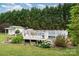 Backyard above-ground pool with surrounding deck and lush landscaping offering a private and relaxing outdoor space at 1720 Lowe Dr, Catawba, NC 28609