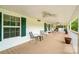 Inviting covered front porch with multiple ceiling fans and seating, offering a relaxing outdoor living space at 1720 Lowe Dr, Catawba, NC 28609