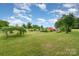 Expansive green yard with scattered trees and outbuildings providing serene rural living at 1720 Lowe Dr, Catawba, NC 28609