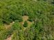 Expansive aerial view of lush wooded property featuring dense trees and natural landscape at 174 Buena Vale Dr, Gastonia, NC 28056